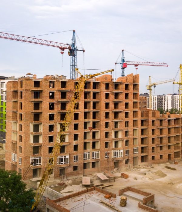 Aerial view of city residential area with high apartment buildings under construction.
